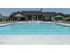 Community pool with clubhouse and lounge chairs for relaxing poolside at 825 Flower Manor Dr, Wendell, NC 27591