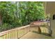 Inviting wooden deck overlooking a lush, green backyard with mature trees and lawn at 919 Orient St, Durham, NC 27701