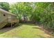 Spacious backyard featuring a wooden deck, a grassy lawn, and mature trees at 919 Orient St, Durham, NC 27701