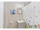 Compact bathroom featuring a gray vanity with a floral shower curtain at 919 Orient St, Durham, NC 27701