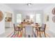 Bright dining room featuring a table set for four, colorful rug, and modern decor at 919 Orient St, Durham, NC 27701