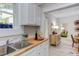 Open kitchen view with butcher block counters, access to dining area, and natural light at 919 Orient St, Durham, NC 27701