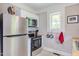 Modern kitchen featuring stainless steel appliances, butcher block countertops, and ample natural light at 919 Orient St, Durham, NC 27701