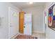 The laundry area includes a stacked washer/dryer and a storage cabinet by the door at 919 Orient St, Durham, NC 27701