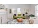 Bright living room showcasing green sofa, natural light, wood coffee table, and a fireplace at 919 Orient St, Durham, NC 27701
