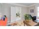 Office leading to living room with colorful area rug and view to adjacent space at 919 Orient St, Durham, NC 27701