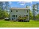 Backyard view of home featuring a wood deck, lush lawn, and a surrounding wood fence at 101 Yuma Dr, Louisburg, NC 27549