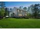Backyard view of home featuring a wood deck, lush lawn, and a surrounding wood fence at 101 Yuma Dr, Louisburg, NC 27549