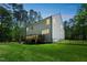 Backyard view of home featuring a wood deck, lush lawn, and a surrounding wood fence at 101 Yuma Dr, Louisburg, NC 27549