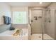 Bathroom with a luxurious tub, a separate glass-enclosed shower and tiled walls at 101 Yuma Dr, Louisburg, NC 27549