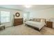 Bedroom with a large window providing natural light, a dresser, and a comfortable bed at 101 Yuma Dr, Louisburg, NC 27549