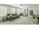 Spacious bedroom with carpet, gray sofa, mini fridge, and a doorway leading to another room or closet at 101 Yuma Dr, Louisburg, NC 27549