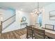 Entryway with dining area and staircase features a decorative mirror, console table, and modern chandelier at 101 Yuma Dr, Louisburg, NC 27549