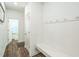Bright entryway featuring hardwood floors, a storage bench, and hooks for coats at 101 Yuma Dr, Louisburg, NC 27549