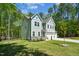 Charming home with a three-car garage, well-manicured lawn, and lush, surrounding trees at 101 Yuma Dr, Louisburg, NC 27549