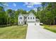 Charming two-story home with a three-car garage, well-manicured lawn, and beautiful, mature trees at 101 Yuma Dr, Louisburg, NC 27549