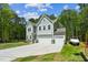 Charming home featuring a three-car garage, well-manicured lawn, and landscaped garden at 101 Yuma Dr, Louisburg, NC 27549