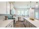 Bright kitchen with modern stainless steel appliances, white cabinets and countertop space, and hardwood style flooring at 101 Yuma Dr, Louisburg, NC 27549
