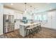 Modern kitchen with stainless steel appliances, white cabinetry, pendant lighting, and center island with bar seating at 101 Yuma Dr, Louisburg, NC 27549