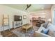 Open concept with living room leading to kitchen, showcasing hardwood floors, stylish furniture, and ceiling fan at 101 Yuma Dr, Louisburg, NC 27549