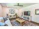 Comfortable living room with ceiling fan, wooden floors, neutral paint, decorative painting, and stylish furniture at 101 Yuma Dr, Louisburg, NC 27549