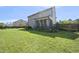A spacious backyard features a screened porch and a lush lawn with a well-maintained fence for privacy at 1010 Smoke Willow Way, Rolesville, NC 27571
