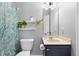 Well-lit bathroom with a modern vanity, toilet, and decorative plants at 1010 Smoke Willow Way, Rolesville, NC 27571