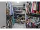 Spacious walk-in closet with ample shelving and hanging storage for clothes and accessories at 1010 Smoke Willow Way, Rolesville, NC 27571