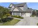 Charming two-story home with a 3-car garage, manicured lawn and beautiful landscaping at 1010 Smoke Willow Way, Rolesville, NC 27571