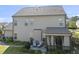 Back exterior elevation featuring a screened porch, patio, and spacious backyard at 1010 Smoke Willow Way, Rolesville, NC 27571