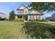 Two-story home with a manicured lawn and beautiful landscaping in the front yard at 1010 Smoke Willow Way, Rolesville, NC 27571