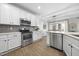 Modern kitchen with stainless steel appliances, quartz countertops, and white cabinets at 1010 Smoke Willow Way, Rolesville, NC 27571