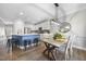 Open kitchen and dining area with stainless appliances, modern lighting, and spacious island with breakfast bar at 1010 Smoke Willow Way, Rolesville, NC 27571