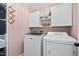 Functional laundry room with modern washer, dryer and storage at 1010 Smoke Willow Way, Rolesville, NC 27571