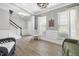 Bright living room with wood floors, fresh paint, abundant natural light, and staircase in the background at 1010 Smoke Willow Way, Rolesville, NC 27571
