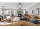 Bright, open living room with a fireplace, access to an outdoor patio, and comfortable leather seating at 1010 Smoke Willow Way, Rolesville, NC 27571