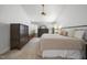 Inviting primary bedroom featuring a large bed, neutral décor, and a dresser at 1010 Smoke Willow Way, Rolesville, NC 27571