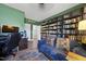 Spacious home office with a desk, bookshelves filled with books, and a comfortable seating area at 1010 Smoke Willow Way, Rolesville, NC 27571
