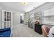 Spacious home office featuring french doors, houseplants, natural light, and a comfortable chair at 1010 Smoke Willow Way, Rolesville, NC 27571