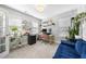 Bright home office featuring multiple houseplants, natural light, and a modern desk at 1010 Smoke Willow Way, Rolesville, NC 27571