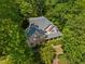 Aerial view of a beautiful house with lush landscaping and mature trees providing privacy and a serene setting at 102 Treadwell Ct, Cary, NC 27513