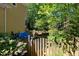 Fenced in backyard with landscaping, flowers, a stone feature and lots of trees at 102 Treadwell Ct, Cary, NC 27513