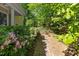 Brick path leads to wooden gate, with landscaping that provides a private backyard area at 102 Treadwell Ct, Cary, NC 27513