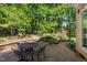 Brick patio features an outdoor dining area and manicured landscaping at 102 Treadwell Ct, Cary, NC 27513