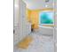 Bright bathroom featuring white cabinets, a soaking tub, and a vanity area at 102 Treadwell Ct, Cary, NC 27513