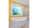 Bright bathroom featuring a window, a soaking tub, and a glass enclosed shower at 102 Treadwell Ct, Cary, NC 27513