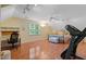 Bright bedroom featuring wood floors, a cozy bed, an exercise machine and a functional desk area at 102 Treadwell Ct, Cary, NC 27513
