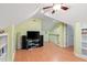 Bonus room offering a media area, ceiling fan, and access to the upstairs landing at 102 Treadwell Ct, Cary, NC 27513