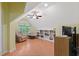 Relaxing bonus room featuring built-in bookshelves, natural light from the window, and ceiling fan at 102 Treadwell Ct, Cary, NC 27513