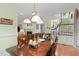 Inviting dining room features a dark wood table and chairs, with elegant lighting fixture overhead at 102 Treadwell Ct, Cary, NC 27513